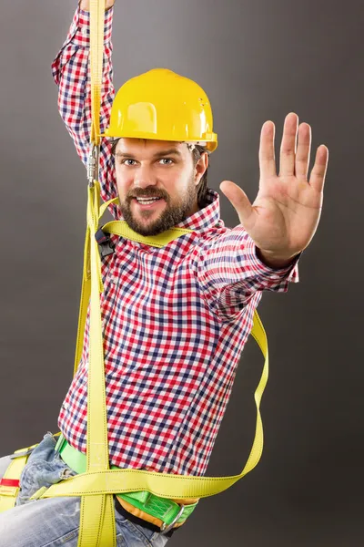 Young construction man with hard hat wearing a fall protection — Stock Photo, Image