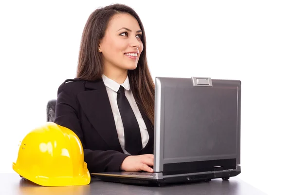 Smiling young businesswoman using laptop — Stock Photo, Image