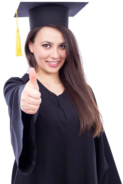 Happy young woman wearing cap and gown with thumb up — Stock Photo, Image