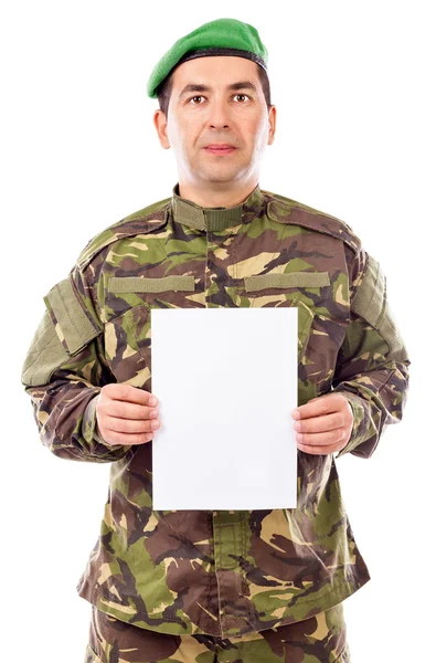 Young soldier holding white sheet of paper — Stock Photo, Image