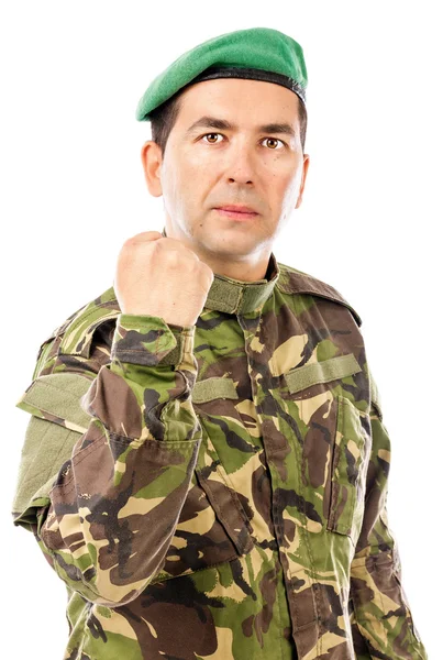 Jovem soldado sério com o braço levantado mostrando seu punho — Fotografia de Stock