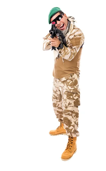 Young excited soldier in army clothes and camouflage aiming with — Stock Photo, Image