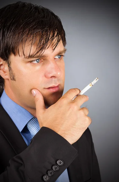 Closeup portrait of young businessman during a break smoking cig — Stock Photo, Image