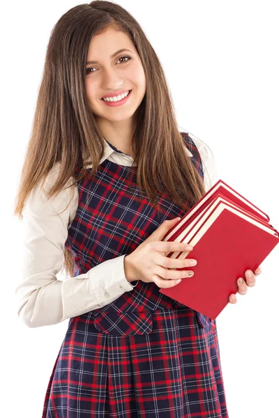 Adorable estudiante sosteniendo un montón de libros —  Fotos de Stock