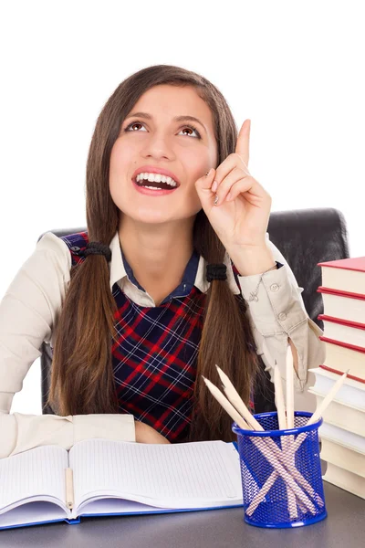 Slimme tiener aan bureau met een briljant idee — Stockfoto