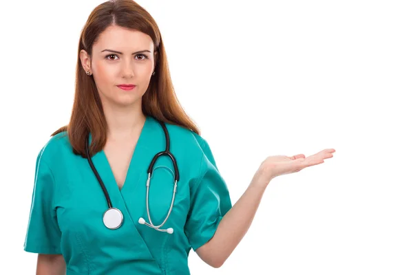 Portrait of young female doctor presenting something i — Stock Photo, Image