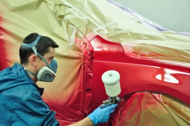 Worker painting a car clipart