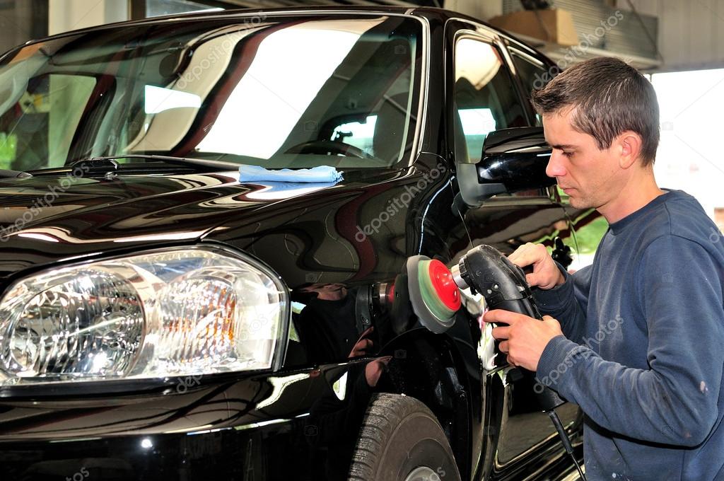 Worker polishing a car. — Stock Photo © lorakss 22189467
