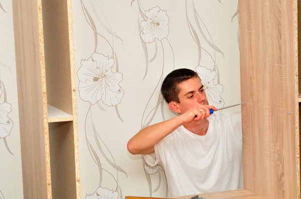 Family man assembling furniture. — Stock Photo, Image