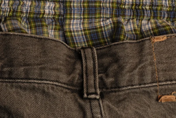 Black denim jeans with plaid boxers — Stock Photo, Image