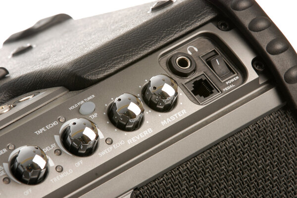 Details on an electric guitar amplifier on white background