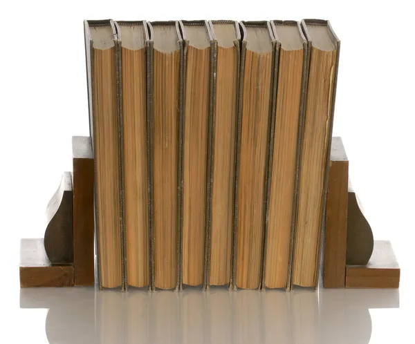 Old books held up with wooden bookends — Stock Photo, Image