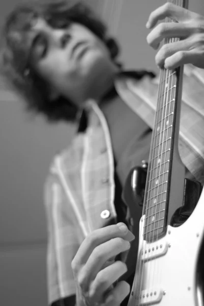Fourteen year old teenage boy playing or practicing guitar — Stock Photo, Image