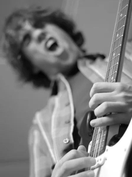 Fourteen year old boy playing his electric guitar — Stock Photo, Image