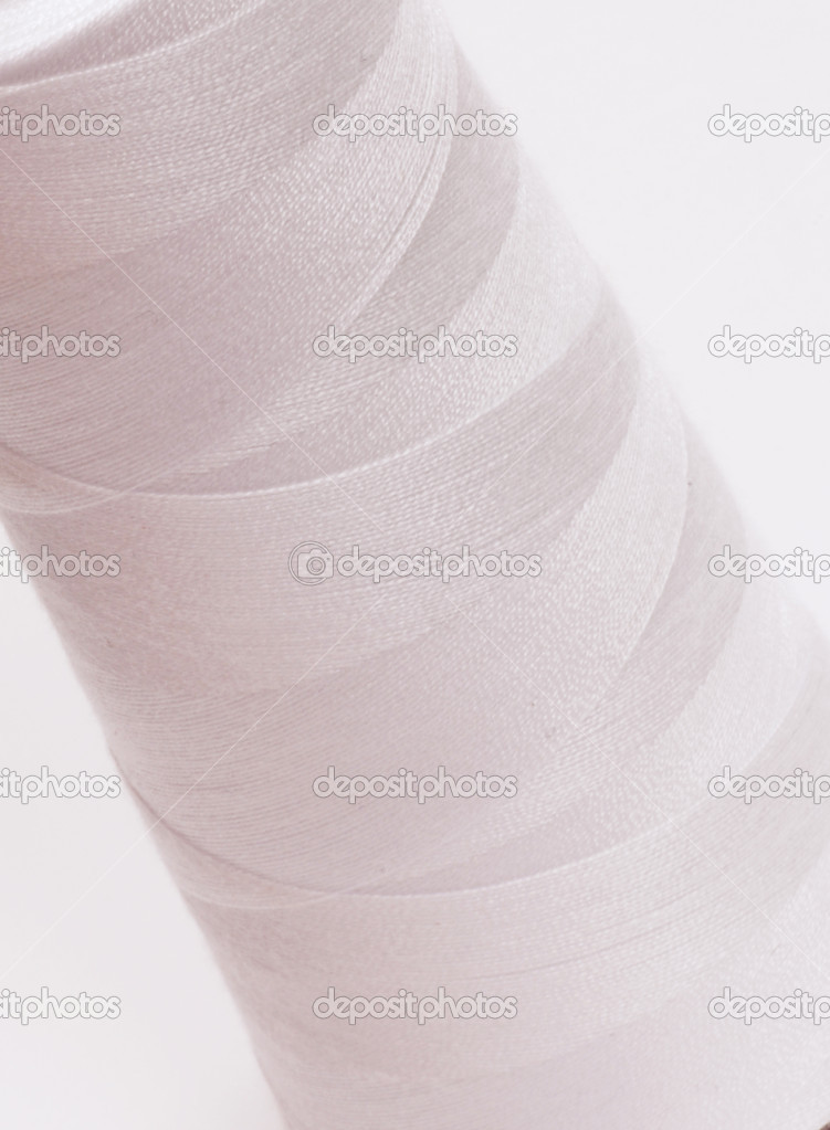 close up details of tightly wound spool of thread