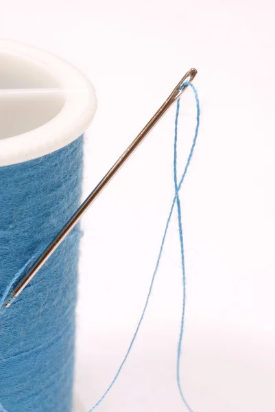 Close up of threaded needle with blue thread — Stock Photo, Image