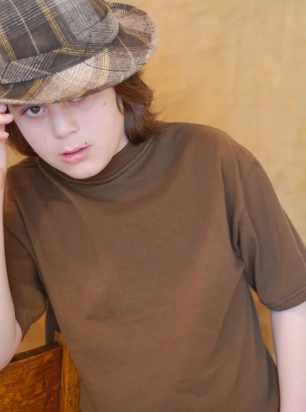 Twelve year old boy wearing hip plaid hat — Stock Photo, Image