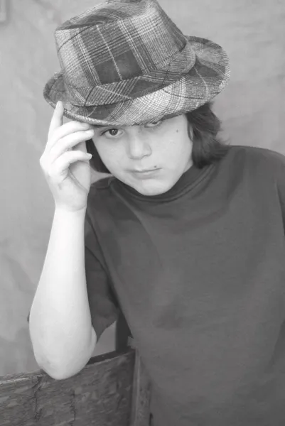 Twelve year old boy wearing hip plaid hat — Stock Photo, Image