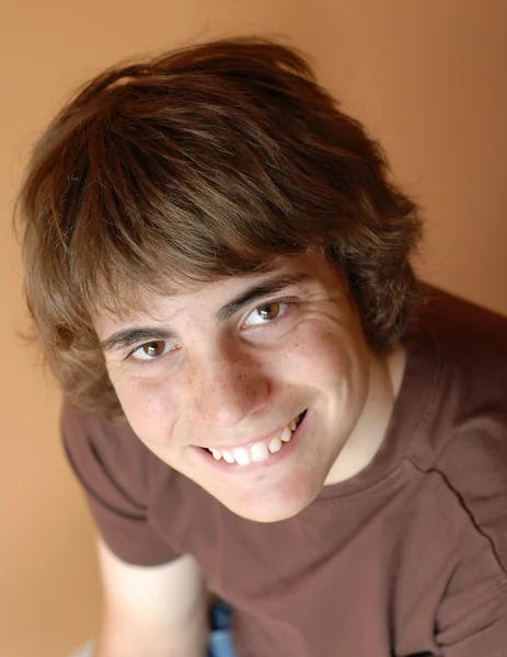 Happy teenage boy with brown expressive eyes — Stock Photo, Image