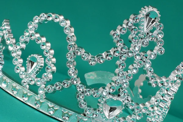 Tiara or crown on green background — Stock Photo, Image