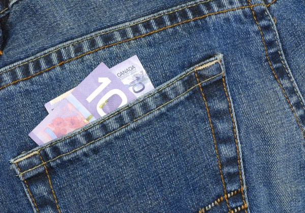 Canadian ten dollar bill in back pocket of blue jeans — Stock Photo, Image