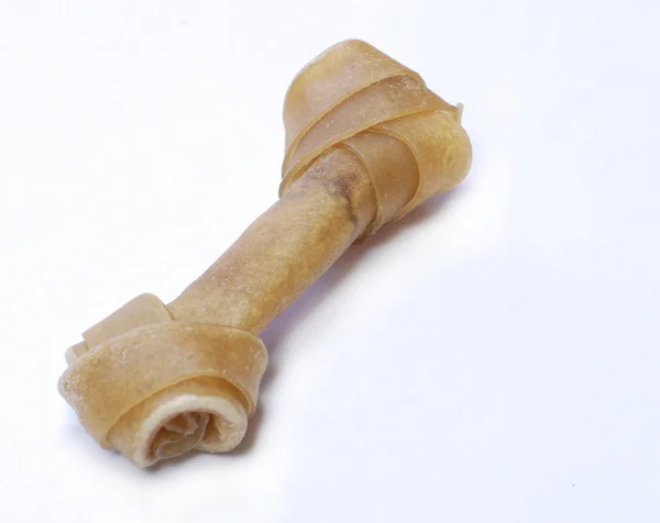 Twisted rawhide bone on white background — Stock Photo, Image