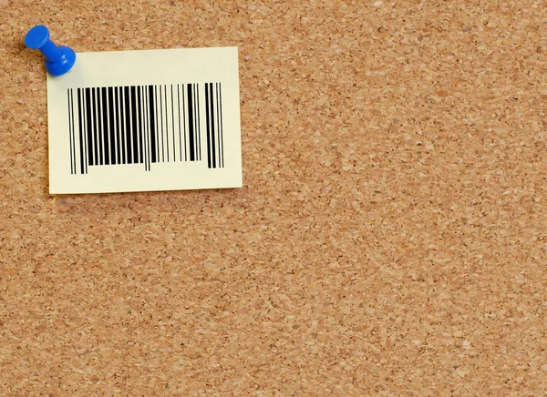 Corkboard with note that has barcode on it — Stock Photo, Image