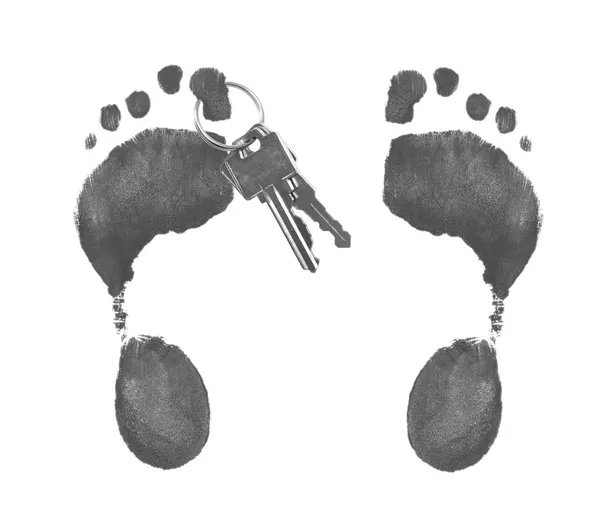 Two foot prints with car keys hanging off — Stock Photo, Image