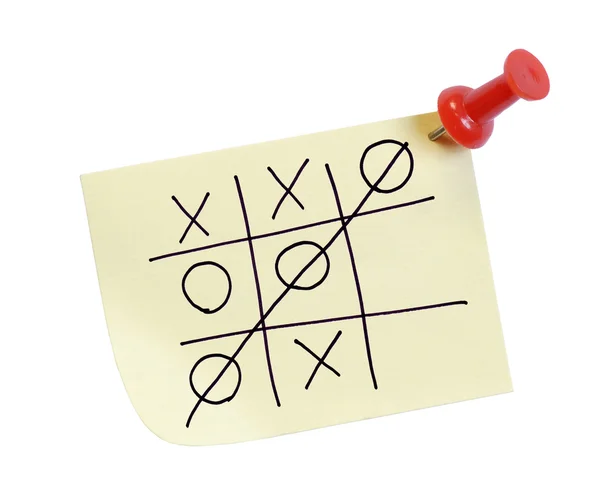 Thumb tacked note with game of tic tac toe — Stock Photo, Image