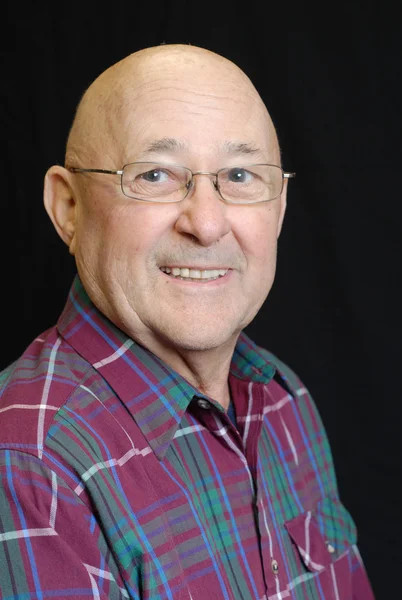 Portrait of bald senior man on black background — Stock Photo, Image