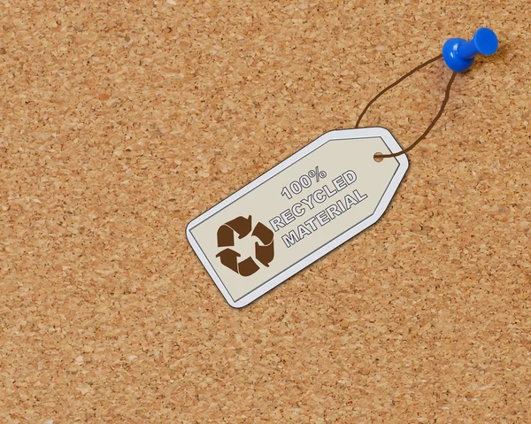 Recycled material tag attached to corkboard with thumb tack — Stock Photo, Image