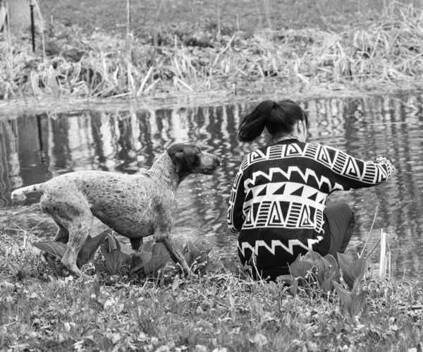 dog and owner by the water