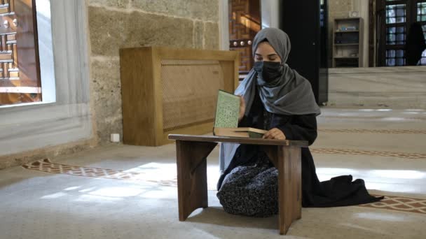 Διαβάζοντας Holly βιβλίο, Μασκοφόρος μουσουλμάνα γυναίκα ανάγνωση quran στο ισλαμικό masjid — Αρχείο Βίντεο