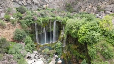 Aerial yerkopru waterfall, aerial shot of Yerkopru waterfall, natural beauties of turkey, stream bed flowing through green grass, waterfall lake accumulated in the valley