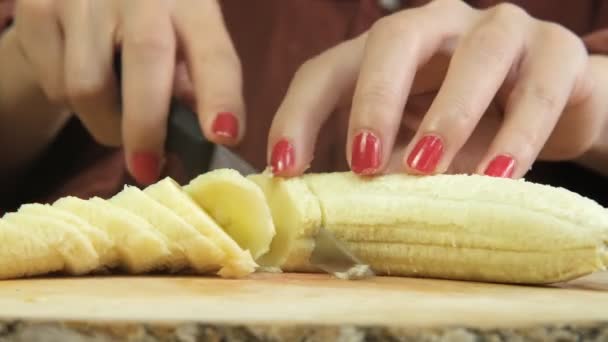Close Shot Yellow Banana Being Cut Knife Woman Red Nail — Vídeos de Stock