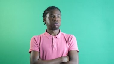 Black man huffing and puffing, male model with a bored expression on his face, show body language and facial expressions in front of a green screen