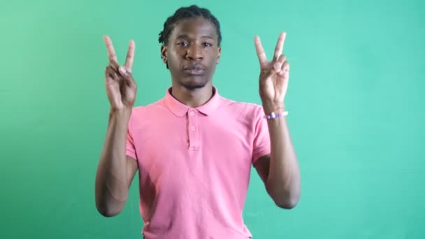 Young Man Pink Shirt Making Victory Sign Hands Black Model — Vídeo de stock
