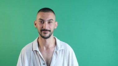 Man doing victory sign, man raising one hand to win sign, successful celestial sign, facial expressions image taken portrait in front of green screen