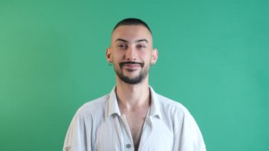 Gestures of happy man face, young male facial expressions laughing happily, facial expressions image taken portrait in front of green screen