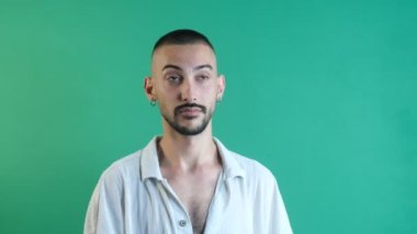 Man pointing the right corner, advertising image pointing to the right corner, facial expressions image taken portrait in front of green screen