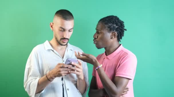 Two Male Friends Who One Black Other White Looking Phone — Vídeo de Stock