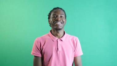 Black man smiling, happy and positive facial expression, happy black male with smiling teeth and mouth structure, show body language and facial expressions in front of a green screen
