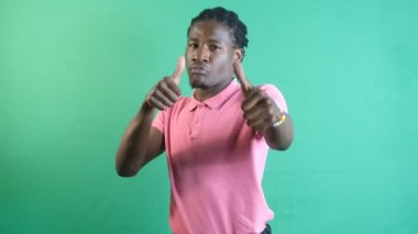 Man making like sign, black teenager making a like sign with both hands, show body language and facial expressions in front of a green screen