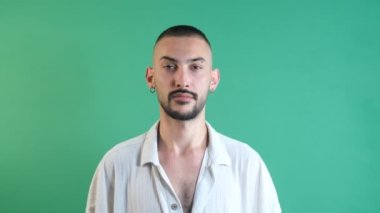 Facial expression of sad man, the expression of unhappiness on the face of the model in front of the green screen