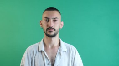 Male facial expression while listening to someone else, listening without speaking facial gestures, facial expressions image taken portrait in front of green screen