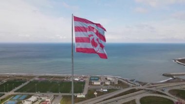 Aerial view of trabzonspor flag next to trabzonspor stadium, drone shot football club flag with a sea view and football antrenman fields, Trabzon Turkey