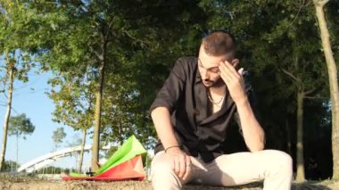 Man with shopping anxiety, social message anxiety from shopping, consuming is not happiness, young expression getting angry looking at the bags he bought