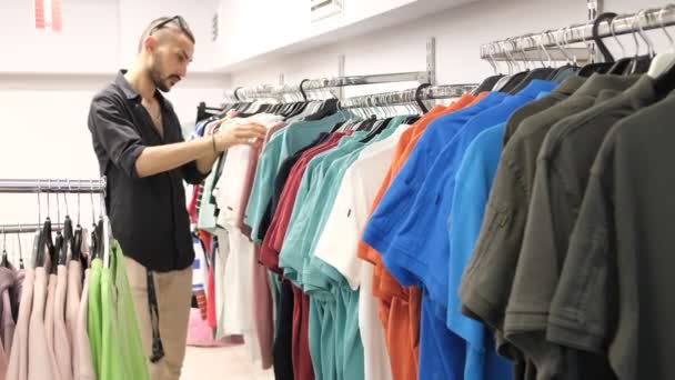 Young Shopper Looking Products Aisle One One Examine Colorful Clothes — 图库视频影像