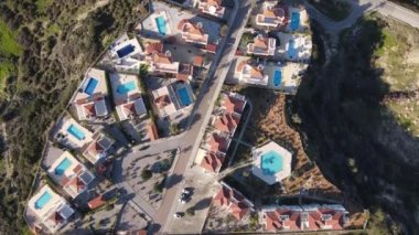 Drone view of the famous holiday sites of Cyprus, tourist hotels built for summer holidays, swimming pools and buildings in green nature