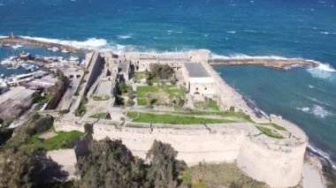 Inside the walls of the historical castle built by the sea, Kyrenia castle taken by drone from the air, Girne protected by the castle walls